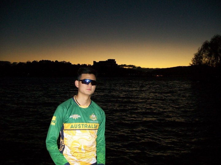Jun in his Australia jersey at the lake edge at dusk, Lake Burley Griffin