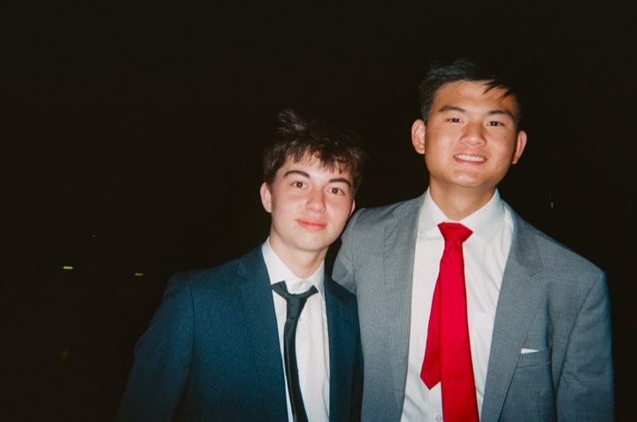 Jun in a grey suit with a red tie at the formal, on film
