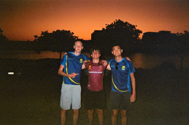Teammates against a warm orange sunset at Kawana, on film
