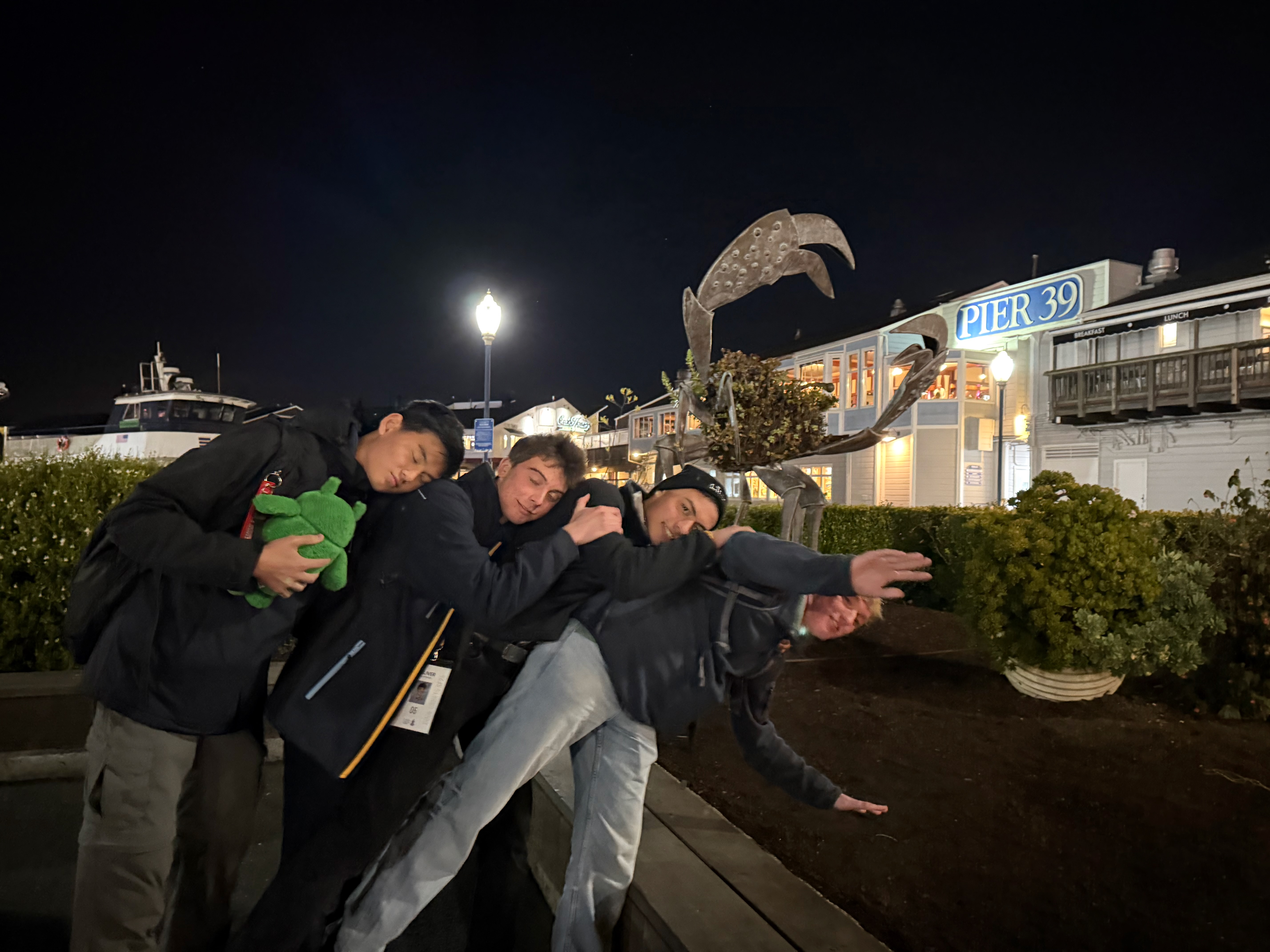 Friends goofing around at Pier 39 at night